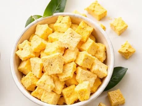 Freeze-dried mango cubes in a bowl