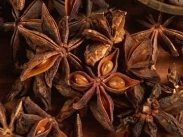 Whole star anise on a wooden surface